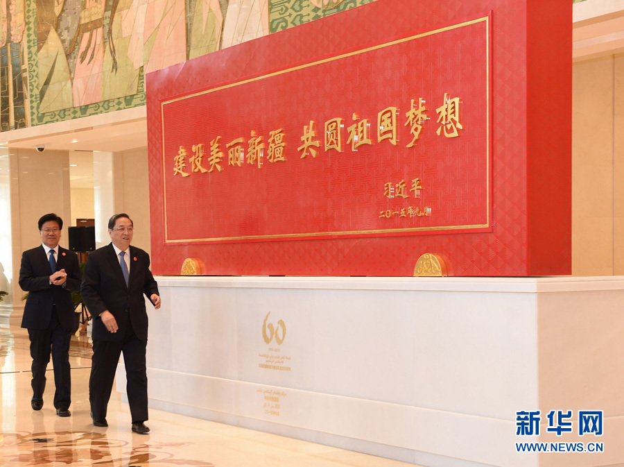 這是俞正聲和中共中央政治局委員、新疆維吾爾自治區黨委書記張春賢一同為習近平總書記題詞賀匾揭幕。新華社記者 高潔 攝 